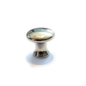 May include: A silver cabinet knob with a round top and a slightly flared base. The knob is labeled "BK-9N".