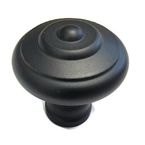 May include: Black cabinet knob with a rounded, layered design. The knob has a smooth, matte finish.