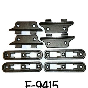 May include: A set of eight black metal brackets and four black metal strips with holes. The brackets have a curved shape and the strips are rectangular. The text "F-9415" is printed below the set.