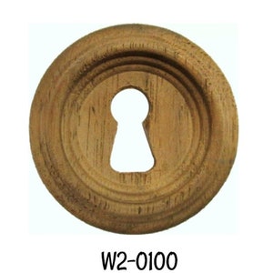 May include: A round, wooden keyhole cover with a keyhole-shaped opening in the center. The cover is made of walnut and has a series of concentric rings carved around the keyhole. The text "W2-0100 Walnut" is below the cover.