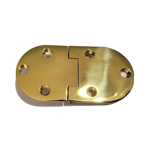 May include: A gold-toned metal hinge with a rounded oval shape. The hinge has five screw holes on each side.