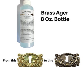 May include: A bottle of Brass Ager, an 8 oz. solution for antiquing brass. The image shows a before-and-after comparison of brass hardware, demonstrating the product's effect. The bottle has a white cap and a blue liquid.