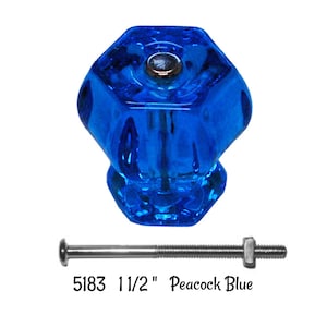 May include: A 1 1/2 inch peacock blue glass cabinet knob with a hexagonal shape and a silver screw.