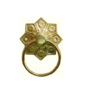 May include: A gold-toned drawer pull featuring a starburst design and a circular handle. The pull has a central, rounded element and is labelled "B-1263" in black text.