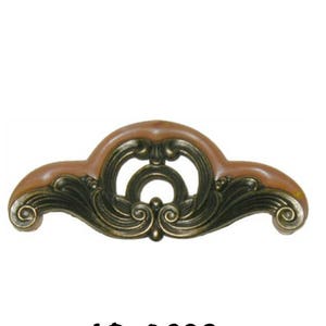 May include: A decorative cabinet hardware pull with a gold finish and a brown center. The pull has a scroll design and the text "AD-0698" is printed below.