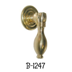 May include: A polished brass door pull with a rounded base and a decorative ring. The pull is labelled "B-1247".