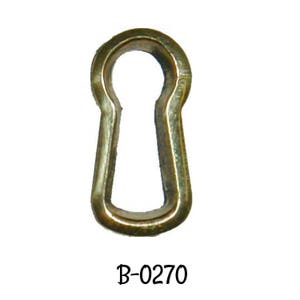 May include: A brass keyhole escutcheon with a rounded top and a smooth, polished finish. The escutcheon is labeled "B-0270".