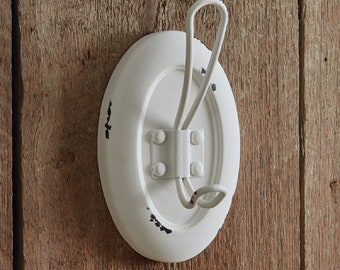 Coat Hook - The Eugenia Wall Hook is made out of metal with a distressed white finish.