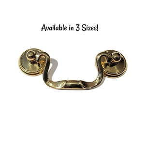 May include: Gold cabinet pull with a rounded, decorative design. Available in 3 sizes.