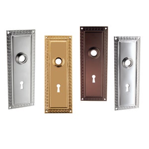 Door trim (escutcheon) stamped wrought brass plate with hub and keyhole for Antique Doors and Door knobs.  Available in five finishes