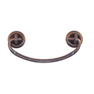 May include: A vintage-style, ornate, copper-toned metal drawer pull with a curved handle and decorative details.