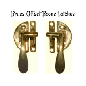 May include: Two brass offset Boone latches. Each latch has a curved handle and a rectangular plate with three holes.