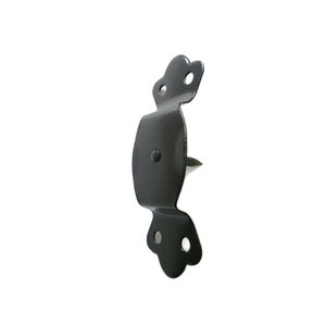 May include: A black metal gate latch with a decorative, curved design. The latch features a pointed spike for securing and is designed to be mounted on a gate or door. The metal has a matte finish and is set against a white background.