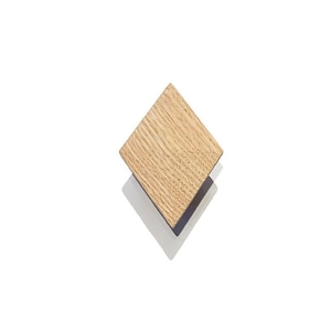 May include: A light brown wooden diamond-shaped knob with a slightly textured surface.