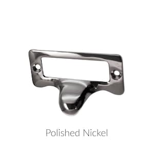 May include: A polished nickel drawer pull with a rectangular label holder. The pull has a rounded, teardrop-shaped handle.