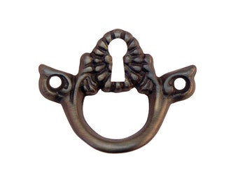 May include: Antique-style keyhole escutcheon with a decorative floral design. The escutcheon is made of metal and has a dark brown finish.