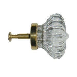 May include: A clear glass cabinet knob with a ribbed design and a gold metal base and screw.