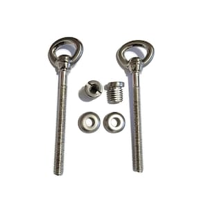 May include: Two silver eyelet screws with washers and nuts. The screws have a threaded shaft and a loop at the top. The washers are round and flat. The nuts are hexagonal.