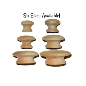 May include: Six wooden knobs in various sizes. The knobs are round and have a smooth, natural finish.  "Six Sizes Available!" is written in black text on a white background.