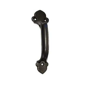 May include: Black metal door handle with a decorative, pointed design at the top and bottom. The handle is curved and has a smooth finish.