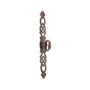 May include: Antique-style keyhole cover with an ornate design and a keyhole in the center. The cover is made of metal and has a dark brown finish.