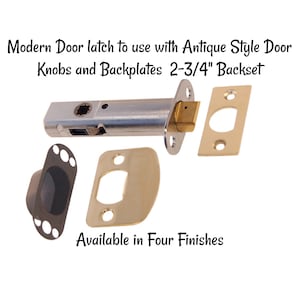 May include: A modern door latch with a silver finish and a brass backplate. The latch is designed to be used with antique style door knobs and backplates. The text "Modern Door latch to use with Antique Style Door Knobs and Backplates 2-3/4" Backset" is visible in the image. The text "Available in Four Finishes" is also visible in the image.