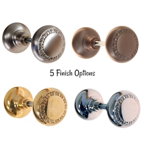 May include: Five door knob options in different finishes: satin nickel, oil rubbed bronze, polished brass, polished chrome, and nickel. Each knob has a decorative, ornate design around the edge.