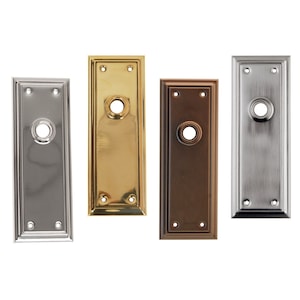 May include: Four door hardware plates in different finishes: polished nickel, brass, oil rubbed bronze, and satin nickel. Each plate has a round keyhole and two small screws.