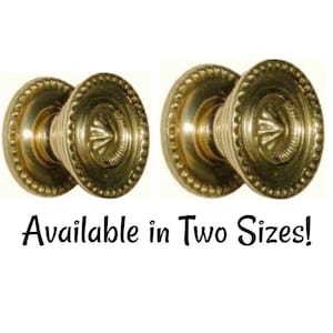 May include: Two gold-toned door knobs with a decorative design. Available in two sizes.
