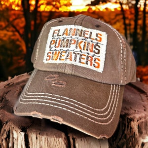 May include: Brown distressed baseball cap with a white patch that says "Flannels, Hayrides, Pumpkins, Bonfires, Sweaters".