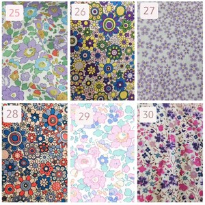 May include: Six different fabric swatches with floral patterns. The swatches are numbered 25 through 30. The patterns include small purple flowers on a white background, large colorful flowers on a yellow background, small purple flowers on a light purple background, large colorful flowers on a white background, pink flowers on a white background, and small purple and pink flowers on a white background.