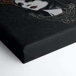 May include: A black and white canvas print of a woman with a gold crown and a necklace made of Arabic calligraphy. The background is black.