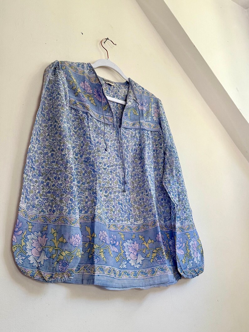 Vintage India Shirt In Featherweight Sheer Cotton Gauze With Pale Floral Print + Ethereal Balloon Sleeves | Deadstock. never been worn vintage Indian peasant blouse in pastel blues and violets. vintage Indian blouse. deadstock vintage India top. sheer cotton gauze India blouse. balloon sleeve India shirt. featherweight Indian gauze blouse. rare deadstock vintage India blouses. hand printed cotton Indian shirts.
