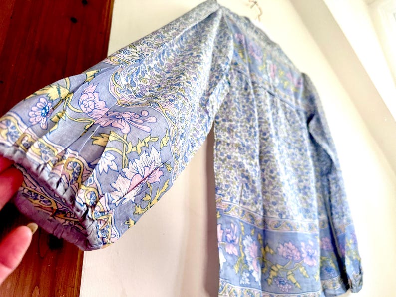 Vintage India Shirt In Featherweight Sheer Cotton Gauze With Pale Floral Print + Ethereal Balloon Sleeves | Deadstock. never been worn vintage Indian peasant blouse in pastel blues and violets. vintage Indian blouse. deadstock vintage India top. sheer cotton gauze India blouse. balloon sleeve India shirt. featherweight Indian gauze blouse. rare deadstock vintage India blouses. hand printed cotton Indian shirts.