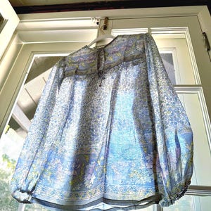 Vintage India Shirt In Featherweight Sheer Cotton Gauze With Pale Floral Print + Ethereal Balloon Sleeves | Deadstock. never been worn vintage Indian peasant blouse in pastel blues and violets. vintage Indian blouse. deadstock vintage India top. sheer cotton gauze India blouse. balloon sleeve India shirt. featherweight Indian gauze blouse. rare deadstock vintage India blouses. hand printed cotton Indian shirts.