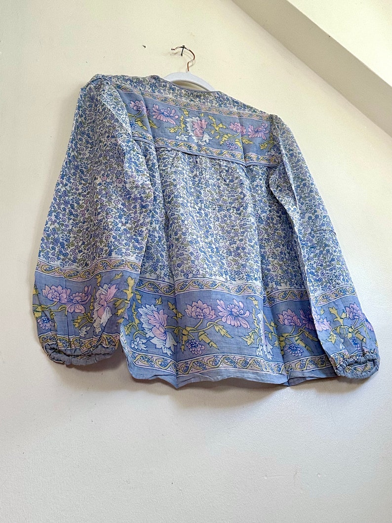Vintage India Shirt In Featherweight Sheer Cotton Gauze With Pale Floral Print + Ethereal Balloon Sleeves | Deadstock. never been worn vintage Indian peasant blouse in pastel blues and violets. vintage Indian blouse. deadstock vintage India top. sheer cotton gauze India blouse. balloon sleeve India shirt. featherweight Indian gauze blouse. rare deadstock vintage India blouses. hand printed cotton Indian shirts.