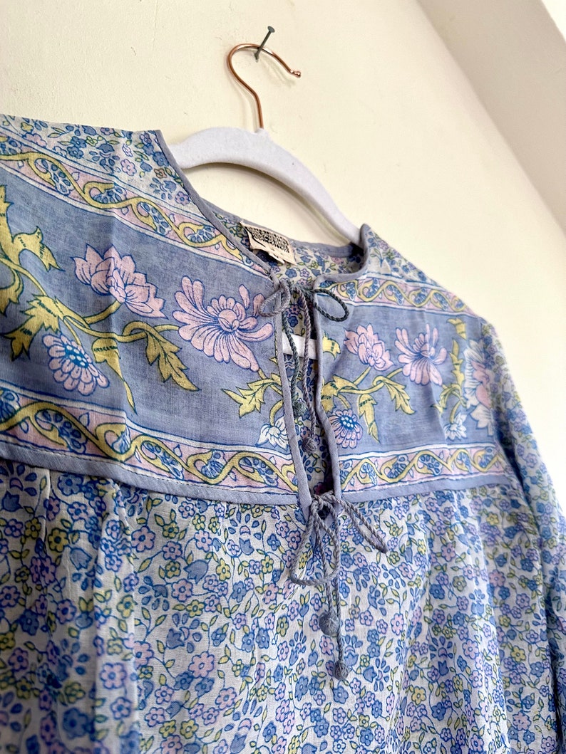 Vintage India Shirt In Featherweight Sheer Cotton Gauze With Pale Floral Print + Ethereal Balloon Sleeves | Deadstock. never been worn vintage Indian peasant blouse in pastel blues and violets. vintage Indian blouse. deadstock vintage India top. sheer cotton gauze India blouse. balloon sleeve India shirt. featherweight Indian gauze blouse. rare deadstock vintage India blouses. hand printed cotton Indian shirts.