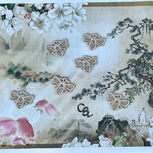 May include: A vintage-style print with a Japanese-inspired design featuring a pine tree, flowers, and goldfishes. Six beige embroidered bee-shaped patches are scattered across the print.