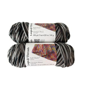 May include: Two skeins of Loops & Threads Soft Classic acrylic yarn. The yarn is a mix of gray, black, and white. Each skein is labeled with "Soft Classic" and "Classique Douce" and contains 252 yards / 5 oz (231 m / 141 g).