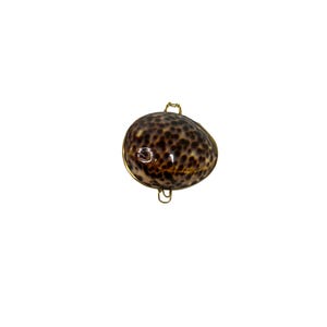 May include: A decorative, oval-shaped shell with a speckled brown and tan pattern, encased in a gold-colored metal frame. The shell has a glossy finish and is suspended by two small, curved metal loops.