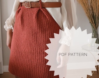 Pode incluir: Uma saia de crochê na cor laranja enferrujado com um cinto marrom. A saia é midi e tem um design simples. O texto "PDF PATTERN" é visível na imagem.