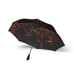 Guarda-chuva dobrável semiautomático Hot Lava: poliéster impermeável - estampa com espirais em vermelho, laranja, preto e amarelo.