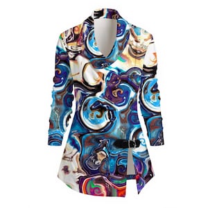 May include: A long-sleeved tunic with an abstract pattern in blue, white, purple, and brown. It has a shawl collar and a black buckle closure. The fabric features a flowing, artistic design. The tunic is a stylish garment.
