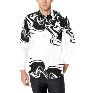 Puede incluir: Una camisa blanca de manga larga con botones y un patr&oacute;n abstracto de espiral en blanco y negro.