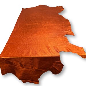 May include: A piece of orange leather with a textured surface.