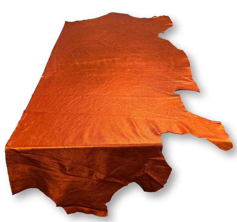 May include: A piece of orange leather with a textured surface.