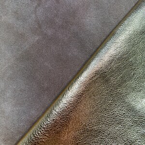 May include: Close-up of two pieces of leather. One piece is a light brown suede and the other is a gold metallic leather.