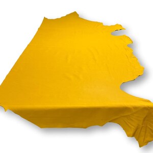 May include: A bright yellow leather hide with a natural, irregular shape.