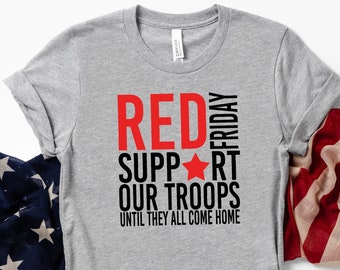 May include: A gray t-shirt with the text "RED FRIDAY SUPPORT OUR TROOPS UNTIL THEY ALL COME HOME" in black and red lettering. A red star is between the words "SUPPORT" and "OUR".