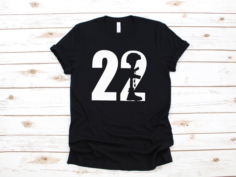 May include: Black t-shirt with a white silhouette of a soldier and the number 22.